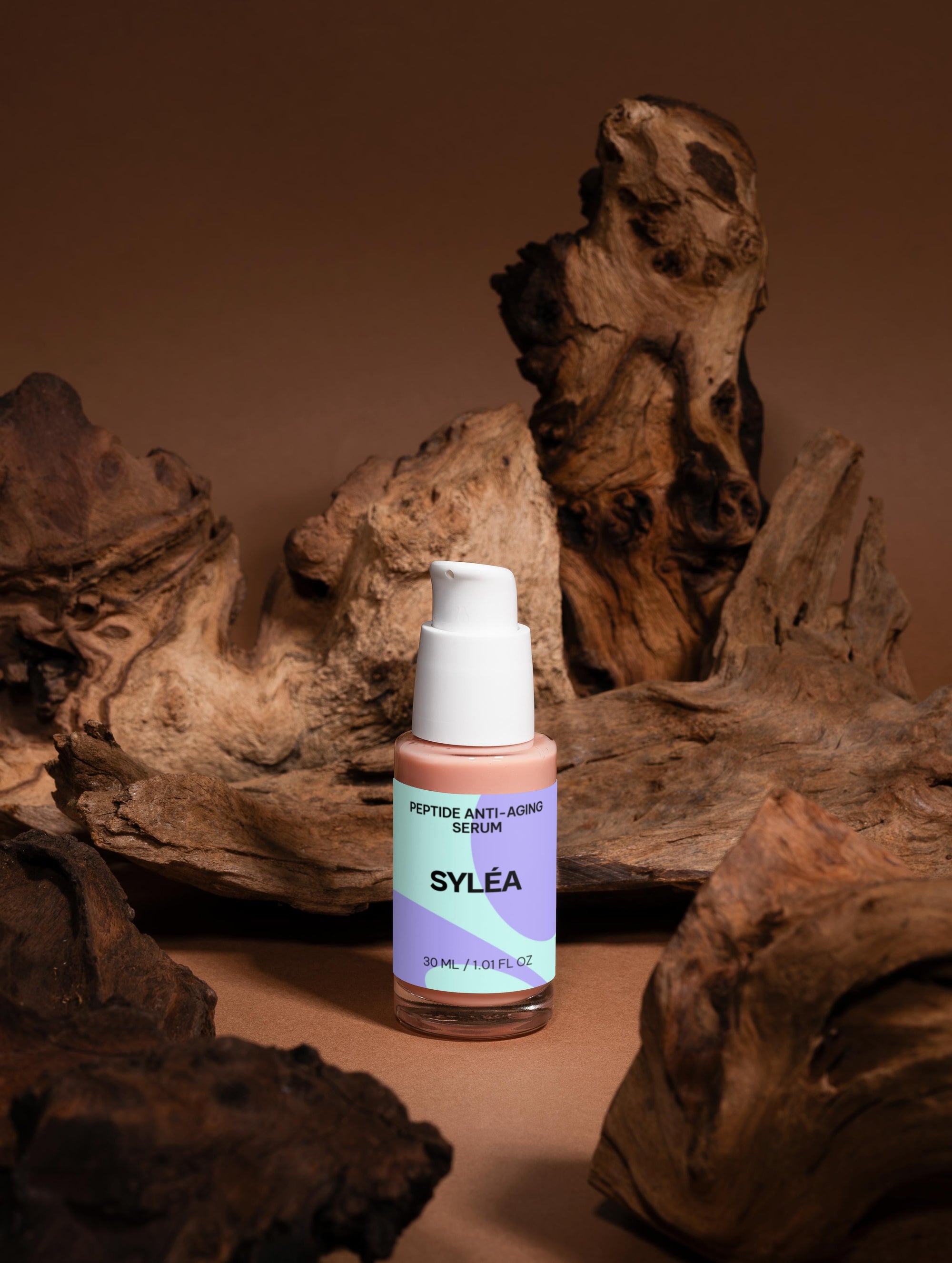 SYLÉA Peptide Anti-Aging Serum 30ml with packaging on brown background with wood elements